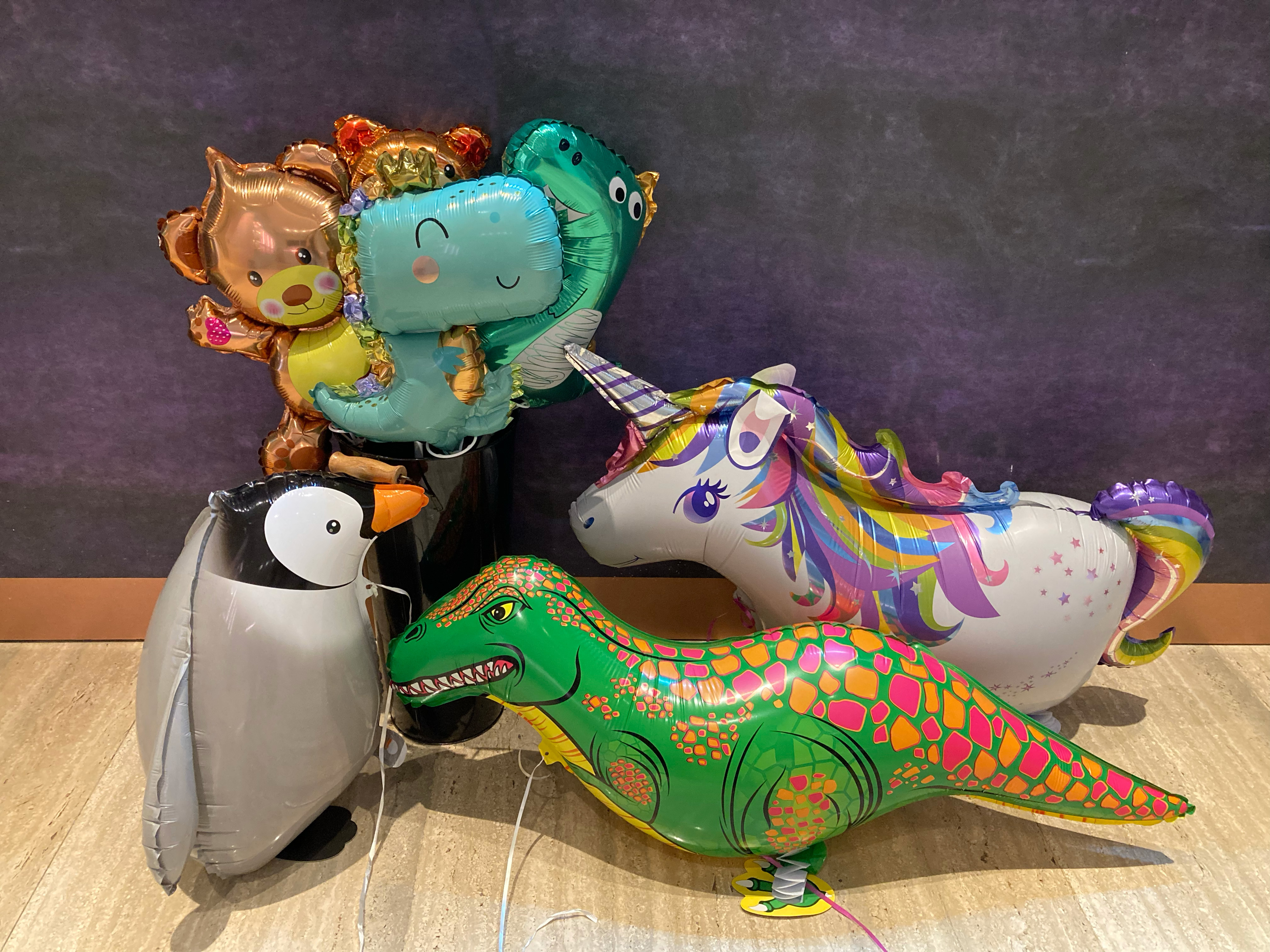 A bunch of animal balloons gathered on the floor.